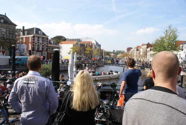 Mensen kijken naar een bootoptreden op de Rijn.