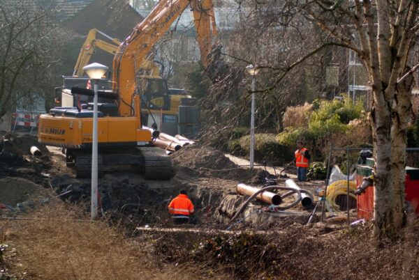 Werklui leggen riool aan in straat.